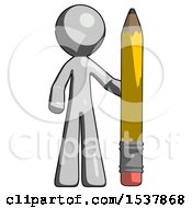 Gray Design Mascot Man With Large Pencil Standing Ready To Write