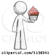 White Design Mascot Man Presenting Pink Cupcake To Viewer