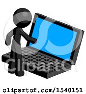 Black Design Mascot Man Using Large Laptop Computer