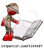 Red Explorer Ranger Man Reading Big Book While Standing Beside It