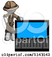 Gray Explorer Ranger Man Beside Large Laptop Computer Leaning Against It