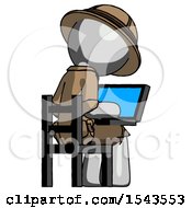Gray Explorer Ranger Man Using Laptop Computer While Sitting In Chair View From Back