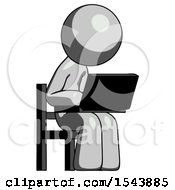 Gray Design Mascot Man Using Laptop Computer While Sitting In Chair Angled Right
