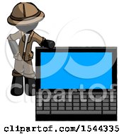 Black Explorer Ranger Man Beside Large Laptop Computer Leaning Against It