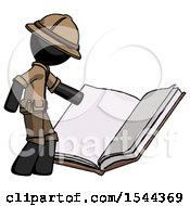 Black Explorer Ranger Man Reading Big Book While Standing Beside It