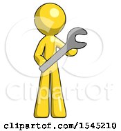 Yellow Design Mascot Man Holding Large Wrench With Both Hands
