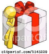 Yellow Design Mascot Man Leaning On Gift With Red Bow Angle View