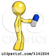Yellow Design Mascot Man Holding Blue Pill Walking To Right