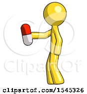 Yellow Design Mascot Man Holding Red Pill Walking To Left