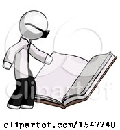 White Doctor Scientist Man Reading Big Book While Standing Beside It