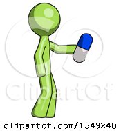 Green Design Mascot Man Holding Blue Pill Walking To Right