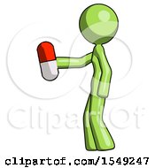 Green Design Mascot Woman Holding Red Pill Walking To Left