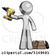 Gray Design Mascot Man Holding Drill Ready To Work Toolchest And Tools To Right
