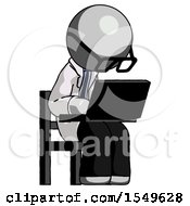 Gray Doctor Scientist Man Using Laptop Computer While Sitting In Chair Angled Right