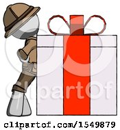 Gray Explorer Ranger Man Gift Concept Leaning Against Large Present