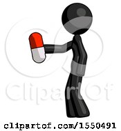 Black Design Mascot Woman Holding Red Pill Walking To Left