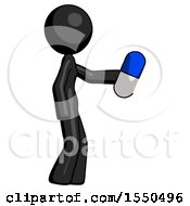 Black Design Mascot Woman Holding Blue Pill Walking To Right