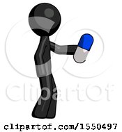 Black Design Mascot Man Holding Blue Pill Walking To Right