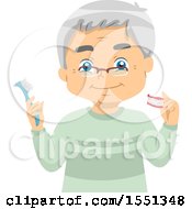 Senior Man Holding A Toothbrush And Dentures