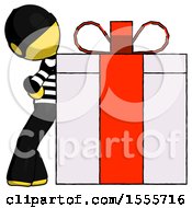 Yellow Thief Man Gift Concept Leaning Against Large Present