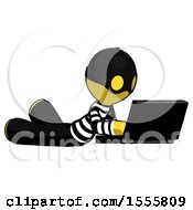 Poster, Art Print Of Yellow Thief Man Using Laptop Computer While Lying On Floor Side Angled View