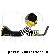 Poster, Art Print Of Yellow Thief Man Using Laptop Computer While Lying On Floor Side View