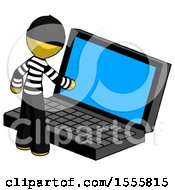 Yellow Thief Man Using Large Laptop Computer