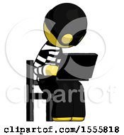Yellow Thief Man Using Laptop Computer While Sitting In Chair Angled Right
