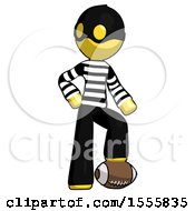 Yellow Thief Man Standing With Foot On Football