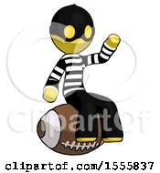 Yellow Thief Man Sitting On Giant Football