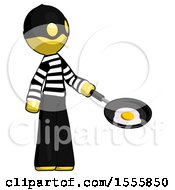 Yellow Thief Man Frying Egg In Pan Or Wok Facing Right