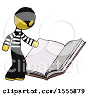 Yellow Thief Man Reading Big Book While Standing Beside It