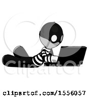 Poster, Art Print Of White Thief Man Using Laptop Computer While Lying On Floor Side Angled View