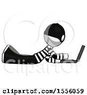 Poster, Art Print Of White Thief Man Using Laptop Computer While Lying On Floor Side View