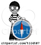 White Thief Man Standing Beside Large Compass