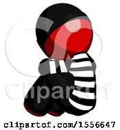 Red Thief Man Sitting With Head Down Back View Facing Left