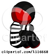 Red Thief Man Sitting With Head Down Back View Facing Right
