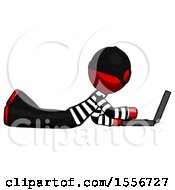 Red Thief Man Using Laptop Computer While Lying On Floor Side View