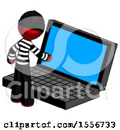 Red Thief Man Using Large Laptop Computer