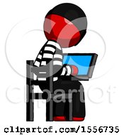 Red Thief Man Using Laptop Computer While Sitting In Chair View From Back