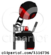 Red Thief Man Using Laptop Computer While Sitting In Chair View From Side