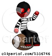 Red Thief Man Sitting On Giant Football