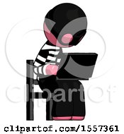 Pink Thief Man Using Laptop Computer While Sitting In Chair Angled Right