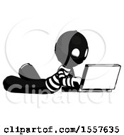 Poster, Art Print Of Ink Thief Man Using Laptop Computer While Lying On Floor Side Angled View