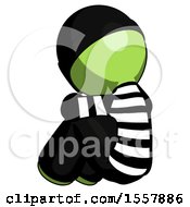 Poster, Art Print Of Green Thief Man Sitting With Head Down Back View Facing Left