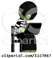 Green Thief Man Using Laptop Computer While Sitting In Chair Angled Right