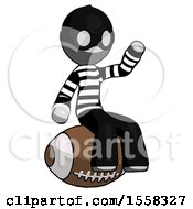 Gray Thief Man Sitting On Giant Football