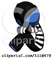 Poster, Art Print Of Blue Thief Man Sitting With Head Down Facing Sideways Left