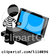 Black Thief Man Using Large Laptop Computer