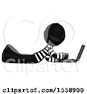 Poster, Art Print Of Black Thief Man Using Laptop Computer While Lying On Floor Side View